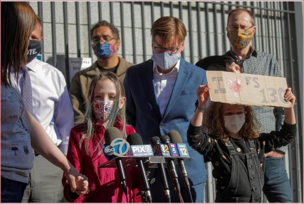 A child speaks to the press during a protest to the closing of Public School 130 outside the school building for safety reasons, following the outbreak of the coronavirus disease (COVID-19) in the Brooklyn borough of New York City, U.S., October 8, 2020. REUTERS/Brendan McDermid